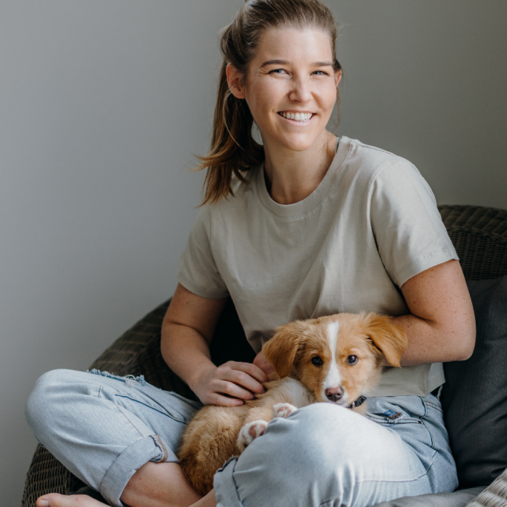 Woman Smiling With A Dog On Her Lap | Fearless Nutrition